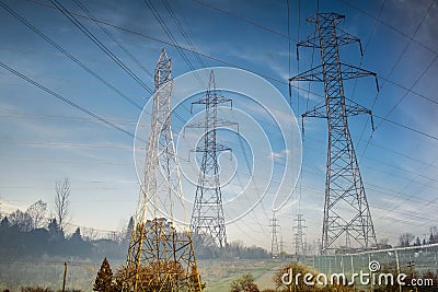 Double Exposure of Pylons in a field Stock Photo