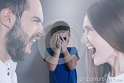 Double exposure of sad boy and his arguing parents Stock Photo