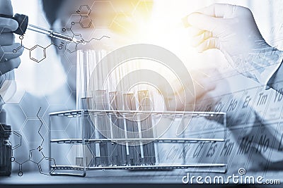 Double exposure of Scientists put a chemical dropper into a test tube and element table during an experiment in a science Stock Photo