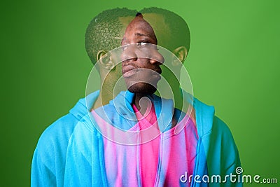 Double exposure shot of young African man against green background Stock Photo