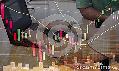 double exposure of stock graph chart candle stick and stock trader using laptop on desk Stock Photo