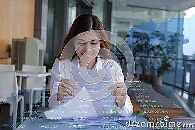 Double exposure of young attractive businesswoman looking document on paperwork against showing growth graphic on background. Busi Stock Photo