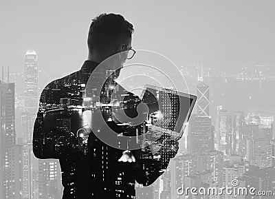 Double exposure young bearded businessman wearing black shirt and holding modern notebook hands. Panoramic view contemporary night Stock Photo