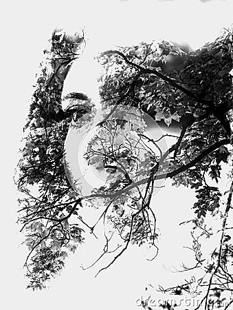 Double exposure of young beautiful girl among the leaves and trees. Portrait of attractive lady combined with photograph of tree. Stock Photo