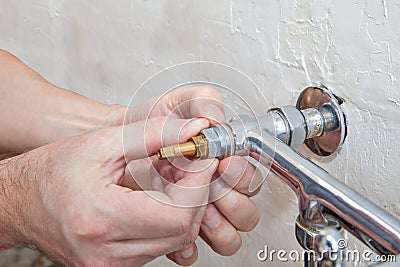 Double handle kitchen faucet repair, plumber hands replacing va Stock Photo