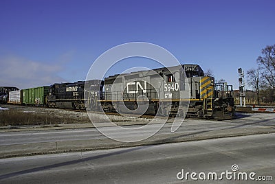 A double header diesel configuration pulls a freight across Broadway Street Editorial Stock Photo