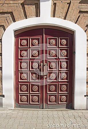 massive wooden doors of a brick house Stock Photo