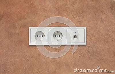 Electric sockets and network line. Light brown background. Close up view with details. Stock Photo