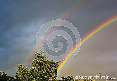 Double Rainbows Over A woodland Setting. Stock Photo
