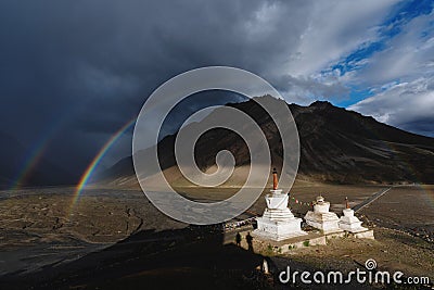 Double rainbows and overcast rainy sky and pagodas in Zanskar valley, India Stock Photo