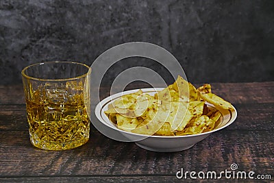 A double of Scotch or whiskey on Ice with chips Stock Photo
