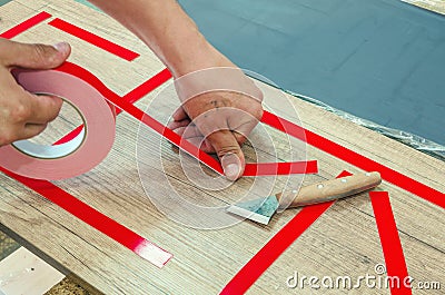 Double-sided tape, the master prepares the part for further sticking the mirror Stock Photo