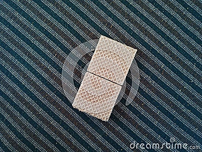 Double Square Cream Wafers on Striped Carpet Stock Photo