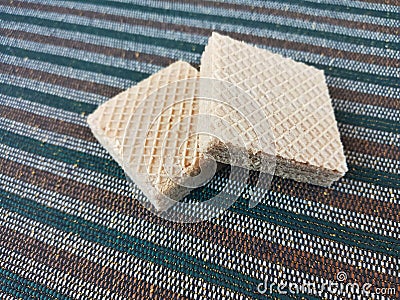 Double Square Cream Wafers on Striped Carpet Stock Photo