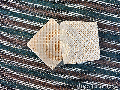 Double Square Cream Wafers on Striped Carpet Stock Photo
