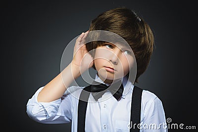Doubt, expression and people concept - boy thinking over gray background Stock Photo