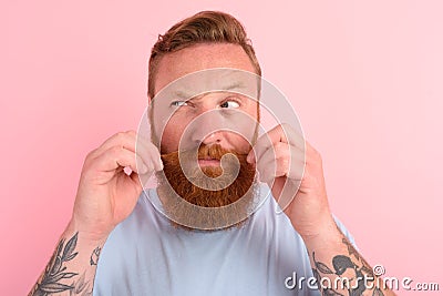 Doubter man with beard and light blue t-shirt Stock Photo