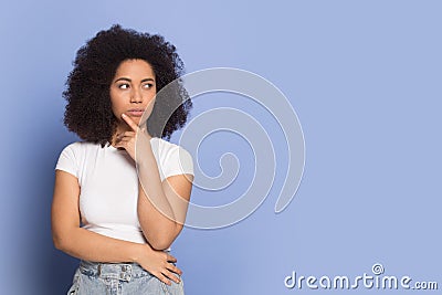 Doubtful african american young lady looking away on empty space. Stock Photo