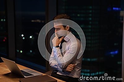 Doubtful businessman ponder by computer hesitate before making risky decision Stock Photo