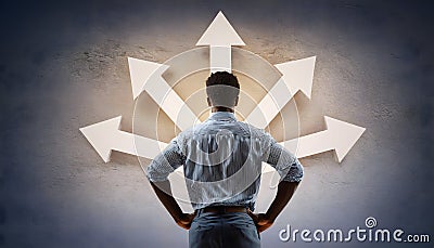 Doubtful person, hands on hips, choosing the way as multiple arrows pointing, showing a mess of different directions Stock Photo