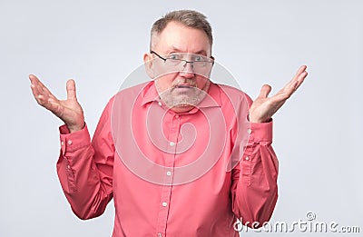 Doubtful senior man in doubt and unsure feeling Stock Photo