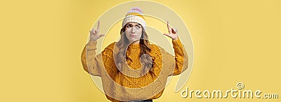 Doubtful unimpressed picky arrogant european girl 20s wearing hat sweater smirking hesitant displeased raising index Stock Photo