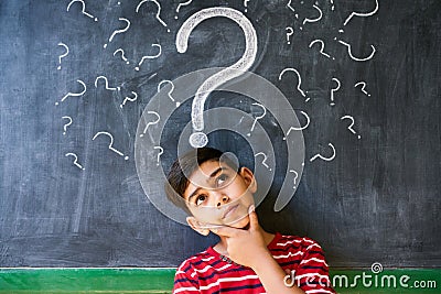 Doubts And Question Marks With Child Thinking At School Stock Photo