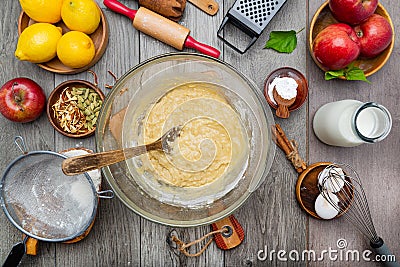 Dough for apple pie in a glass bowl. Ingredients for making sweet apple pie. View from above Stock Photo