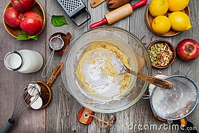 Dough for apple pie in a glass bowl. Ingredients for making sweet apple pie. View from above Stock Photo