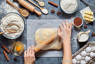 Dough bread, pizza or pie recipe preparation. Female baker hands rolling with pin. Stock Photo