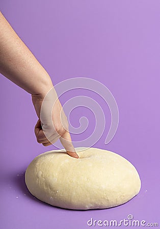 Dough isolated on a purple color. Testing leavened dough. Bread baking Stock Photo