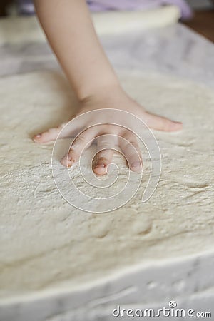 Dough and kid`s hand Stock Photo