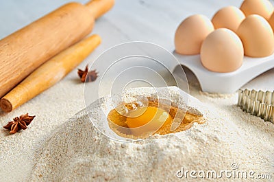 Dough recipe ingredients and accessories on the gray table: eggs, flour, spices and bakewares. Baking background Stock Photo