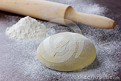 Dough with rolling pin and flour Stock Photo