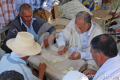 Men playing Dominoes at Traditional Market in Douz, Kebil in Southern Tunisia Editorial Stock Photo