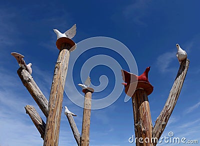 Dove statues on the sticks near entrance to Pigeon valley, beautiful canyon in Cappadocia,Turkey.This historical region is famous Stock Photo