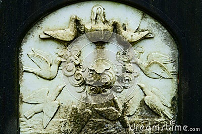 Doves at a fountain bas relief on historic cemetery in Lommel, Belgium Stock Photo