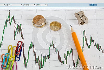 Dow Jones Business chart with paper clips, coins and pencil Stock Photo