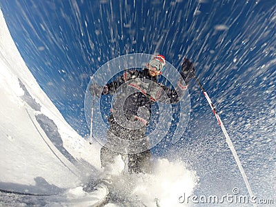 Downhill alpine skiing at high speed on powder snow. Stock Photo