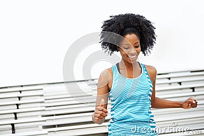 Downhill is easy. a female runner smiling while standing on the rafters. Stock Photo