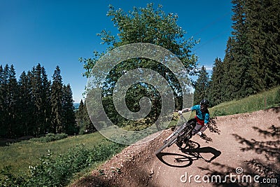 Downhill mountain biking on a shaped bike park trail in Bavaria, Germany Editorial Stock Photo