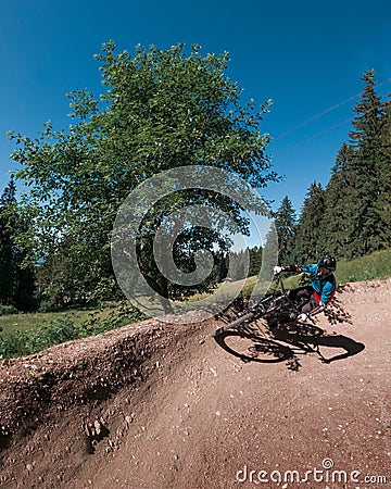 Downhill mountain biking on a shaped bike park trail in Bavaria, Germany Editorial Stock Photo