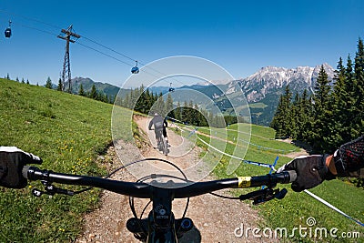 Downhill mountain biking on a shaped bike park trail in mountains of Austria Editorial Stock Photo