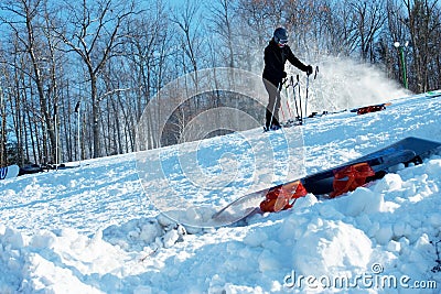 Downhill Skier Holding Poles while Releasing Boots Editorial Stock Photo