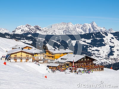 Downhill slope and apres ski mountain hut with restaurant terrace in Saalbach Hinterglemm Leogang winter resort, Tirol Stock Photo