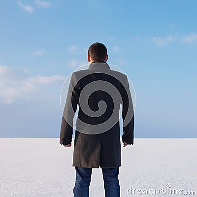 Downshifting way man standing on the shore of a frozen sea relax Stock Photo