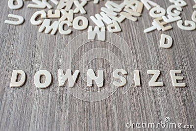 DOWNSIZE word of wooden alphabet letters. Business and Idea Stock Photo