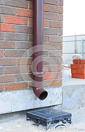 Downspout Gutter Installation with Rainwater Drainage System Installation. Stock Photo