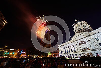 Downtown Fort Wayne courthouse lawn with crowd watching 4th of July fireworks over Lincoln Tower Editorial Stock Photo