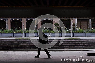 DOWNTOWN VANCOUVER, BC, CANADA - APR 01, 2020: Pedestrian in downtown Vancouver wearing a medical facemask and latex medical Stock Photo